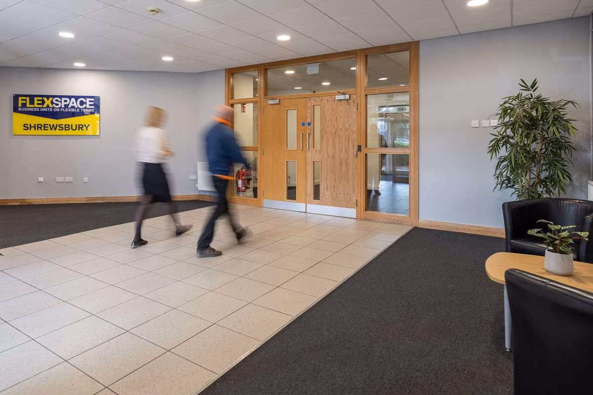The reception area inside FlexSpace Shrewsbury, with the yellow FlexSpace Shrewsbury sign beside the inner doors