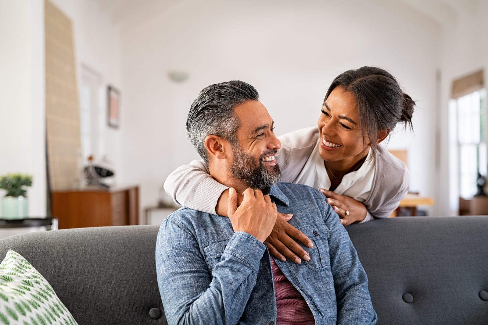 A mature couple laughing together at home