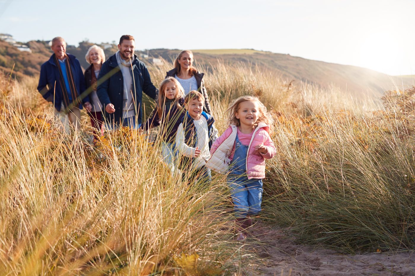A family of several generations walking together outdoors