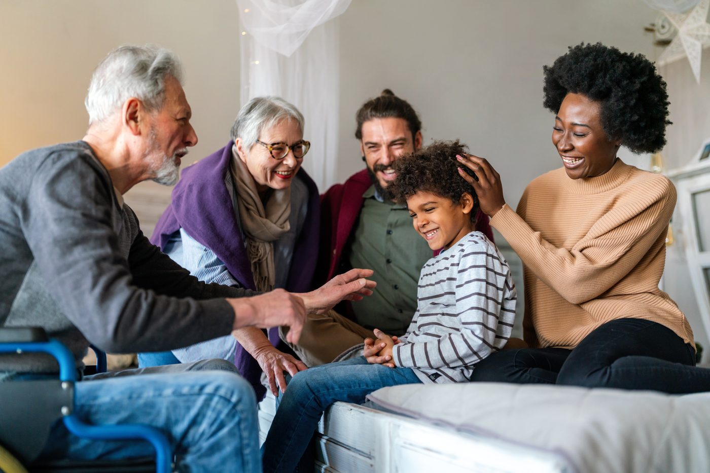 Grandparents, parents and a grandchild together on the sofa