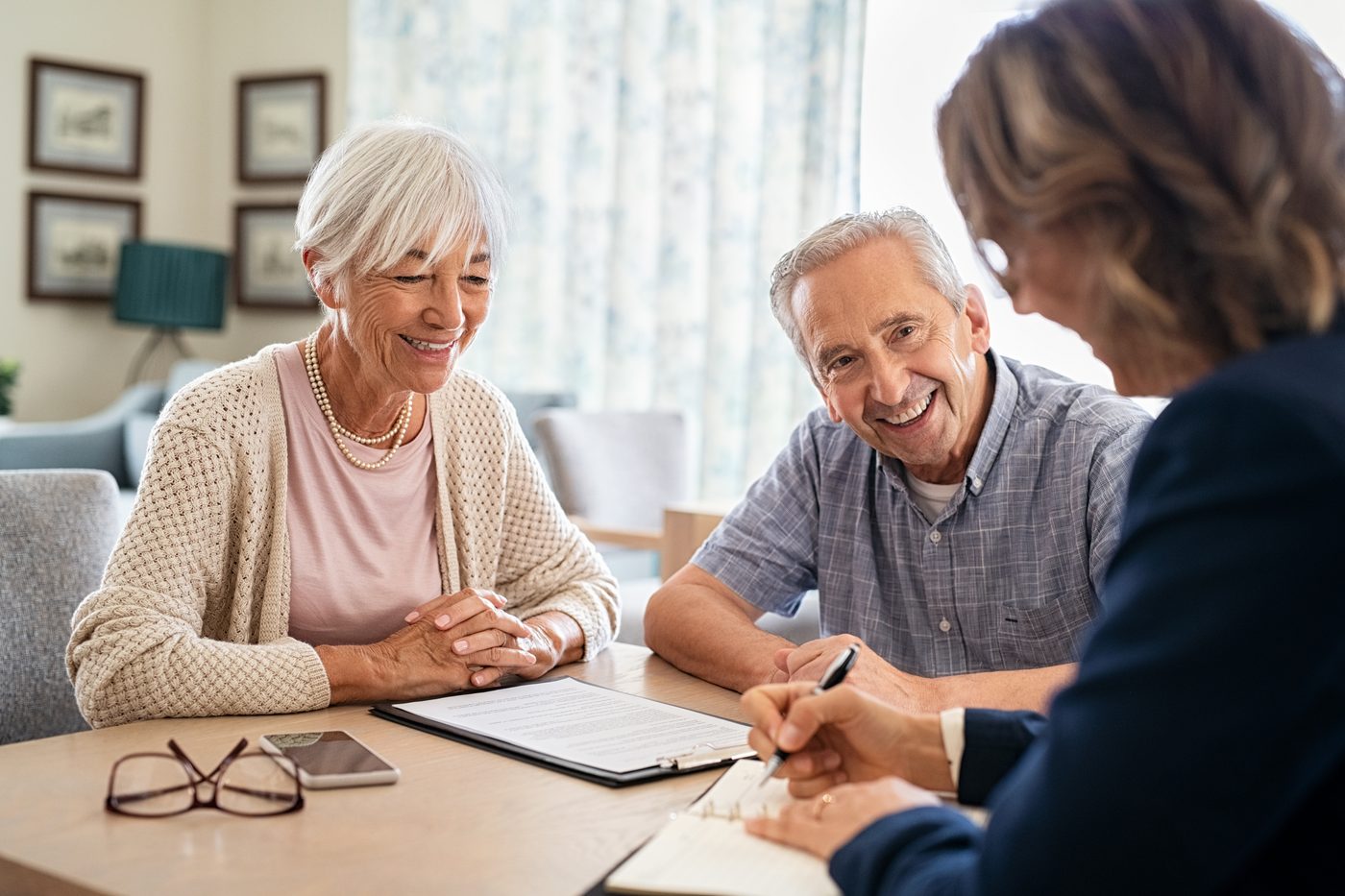 A couple going through paperwork with an adviser
