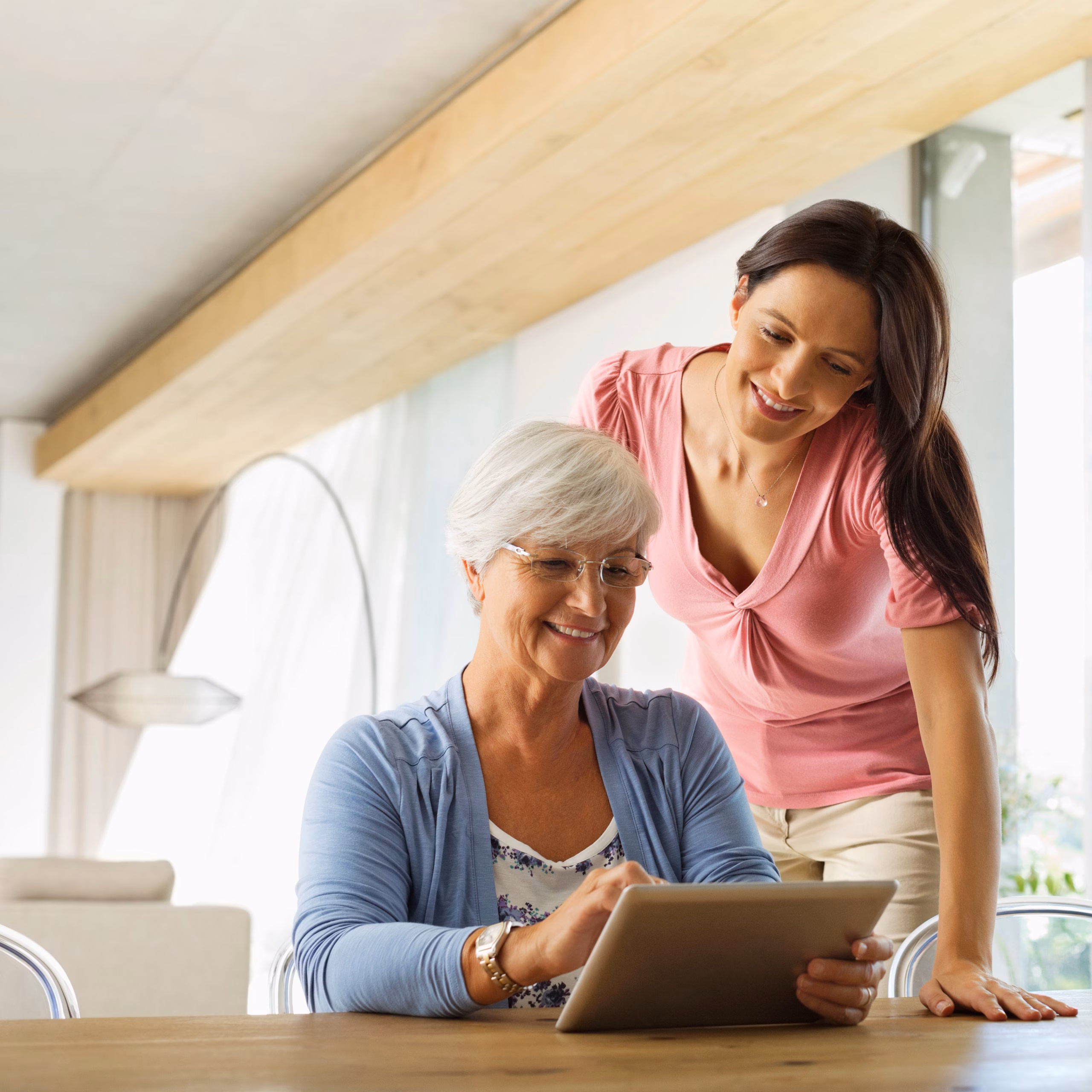 daughter helping elderly mother with paperwork